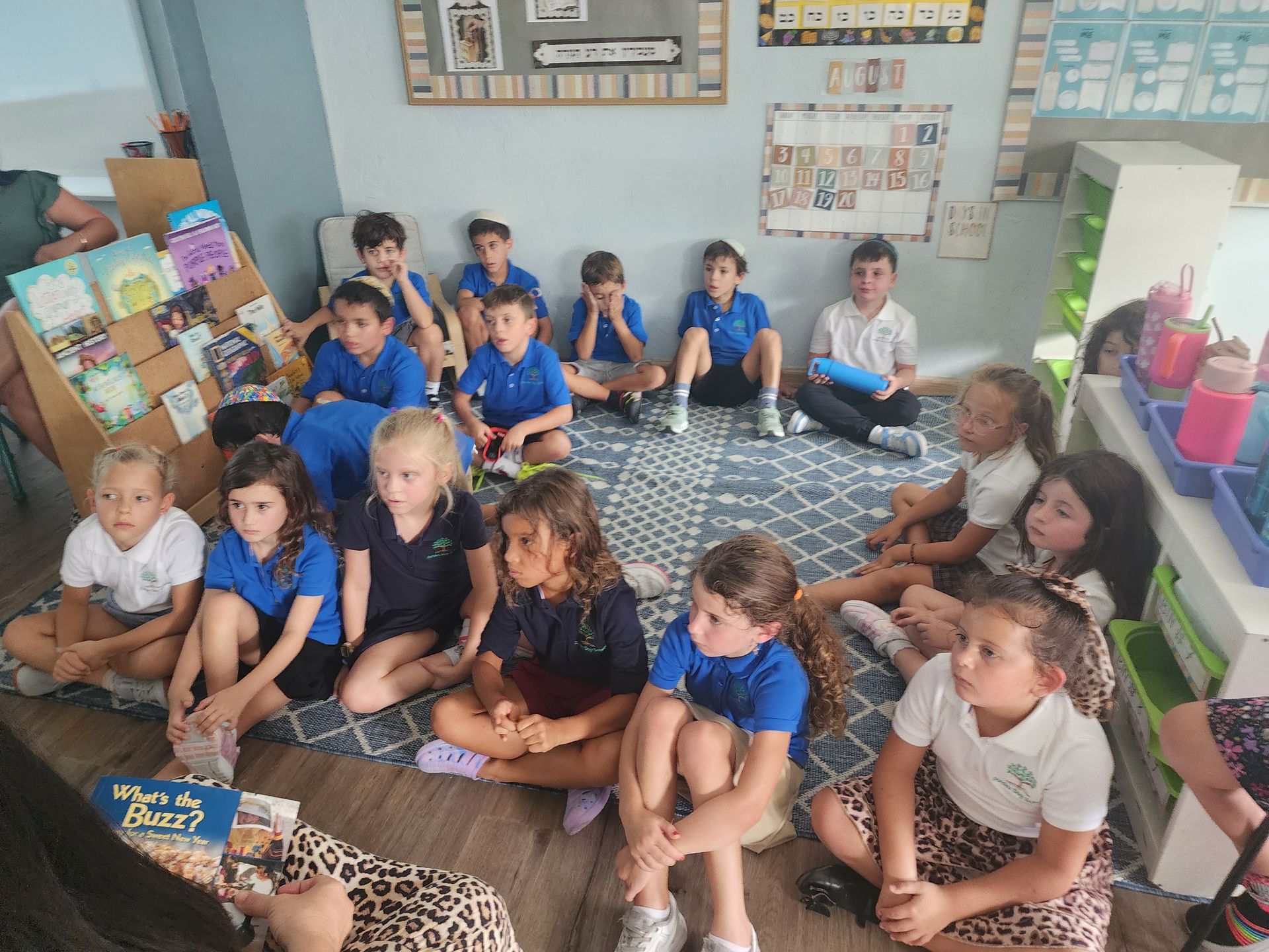 A class gathered on the rug for a story