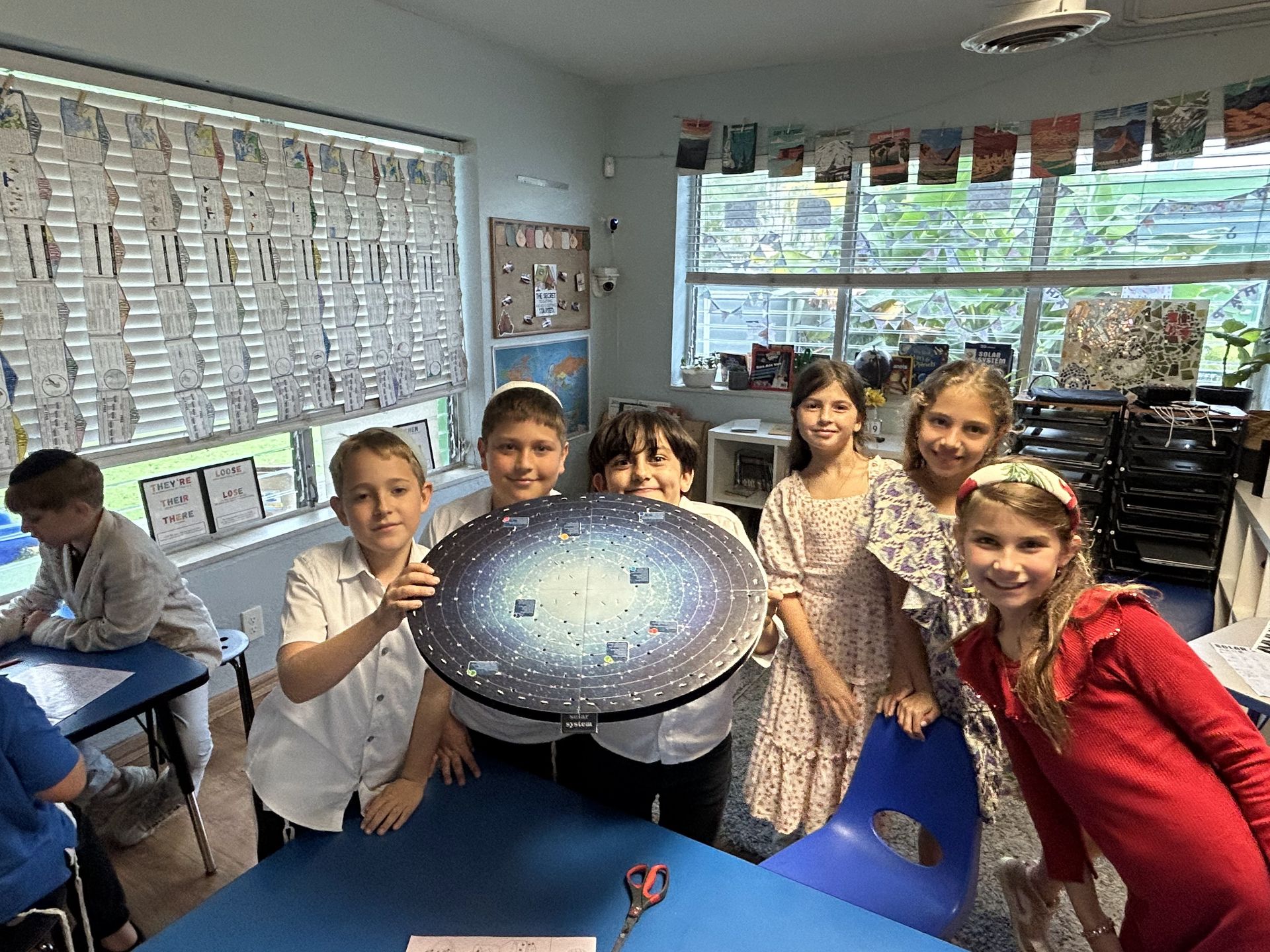 Students holding up a science model