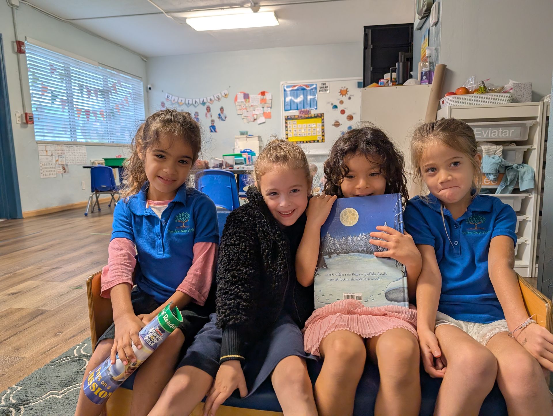 Four students sitting together with a book