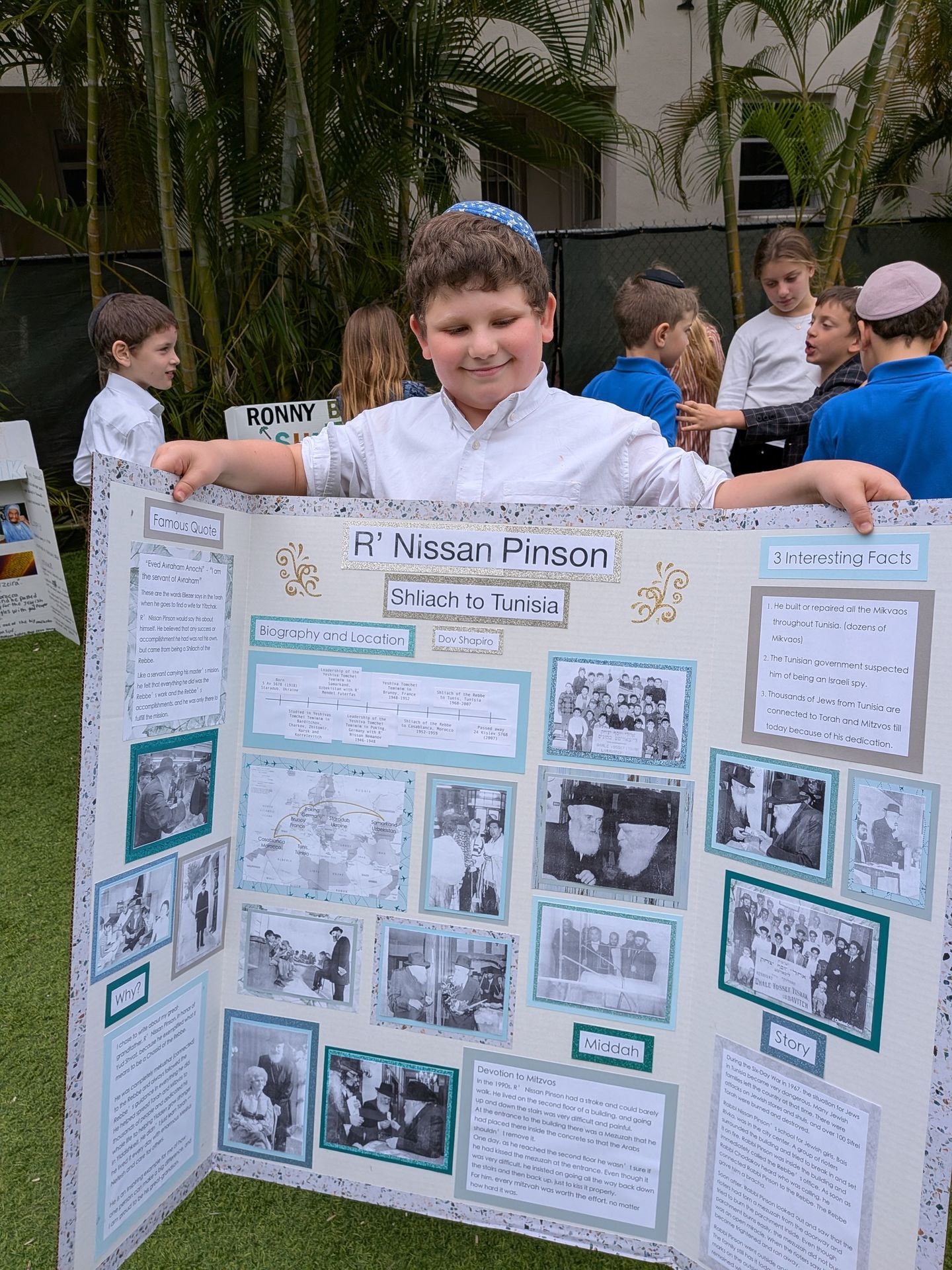 A student presenting his project board