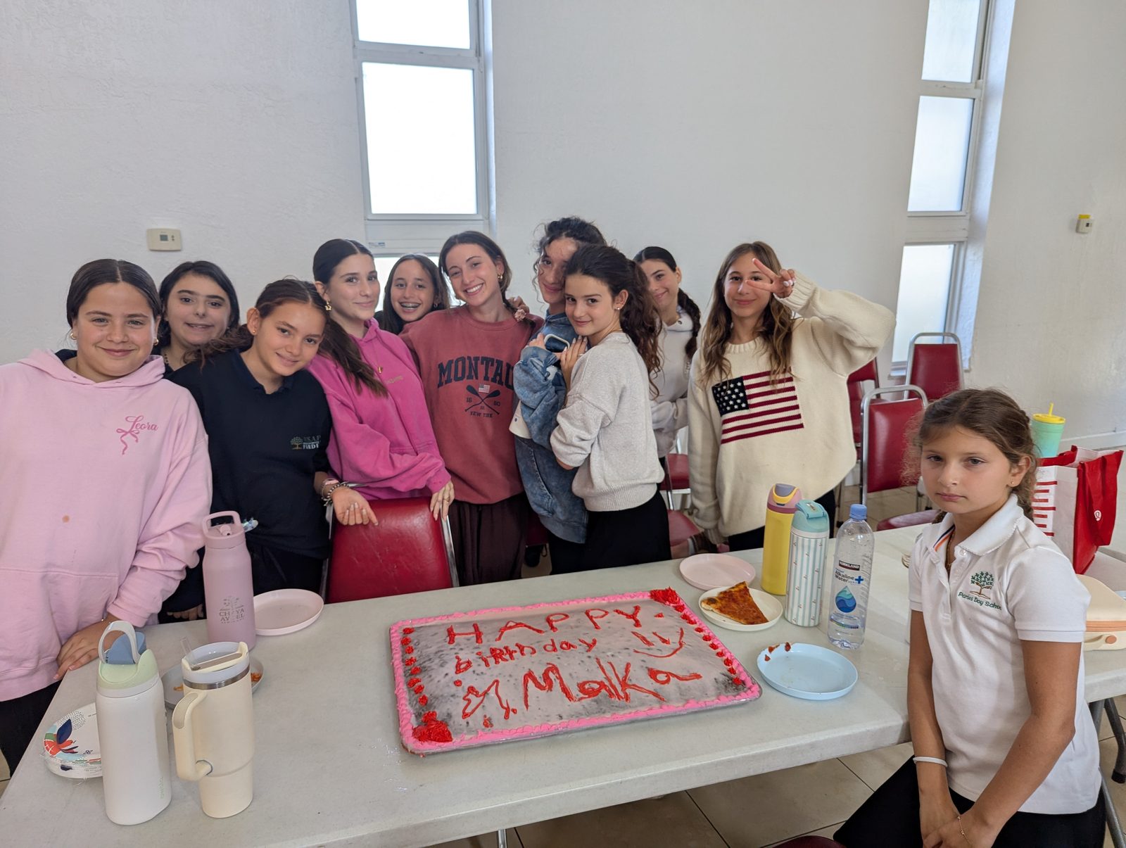 Students celebrating a teacher's birthday together