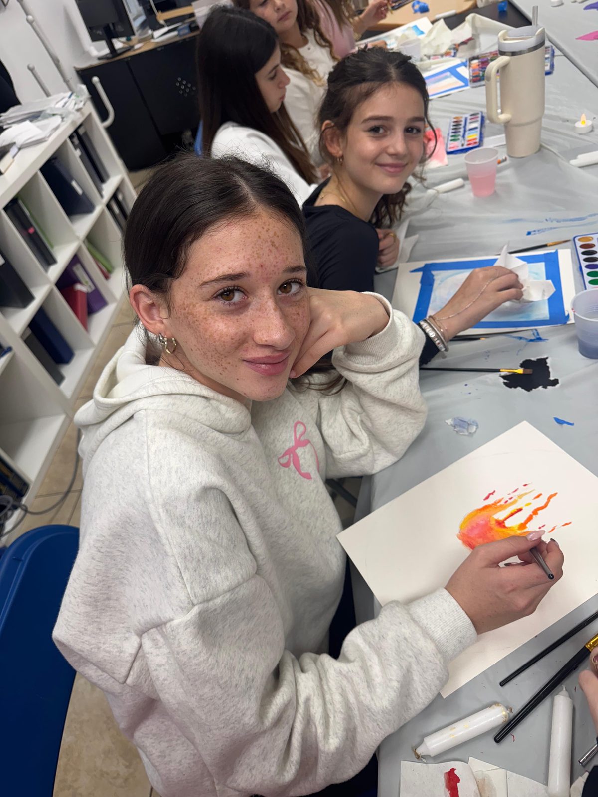 A student painting during art