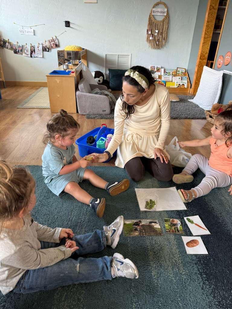 Teacher with preschool children on the rug